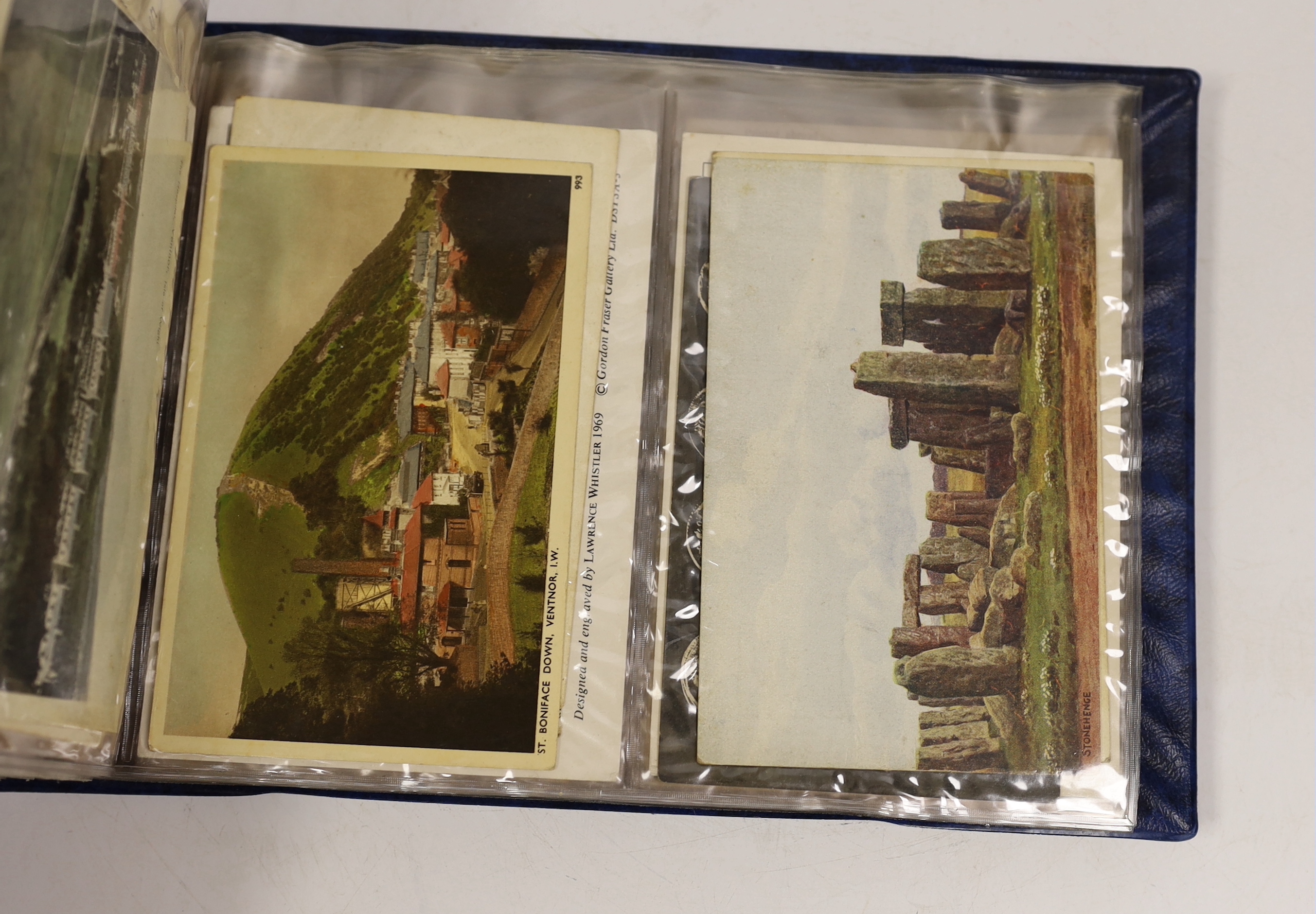 A postcard album, largely continental topography, and eight cards relating to car and motorcycle racing